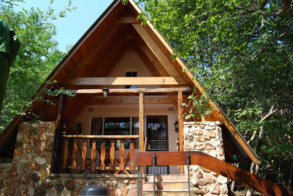 Wooden A-frame cabin tucked into the trees