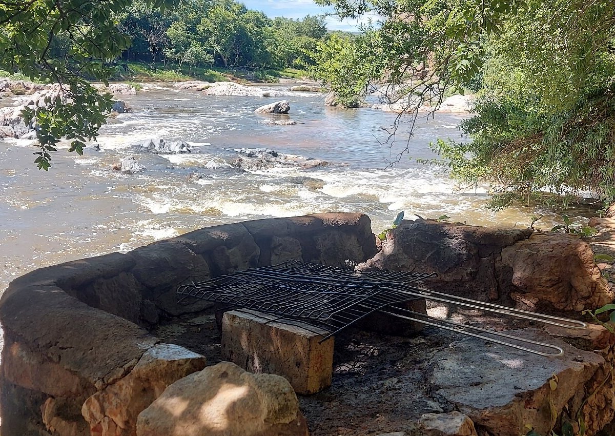 Stone fire pit at the river's edge