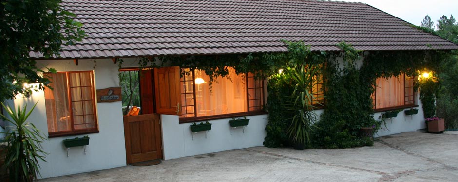 Main lodge at dusk, warmly lit through the windows